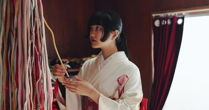 Japanese kimono, woman and obi belt in fabric shop with design choice, pattern decision and decorative accessory. Small business, textile wrap and material match in Tokyo market with cultural designs