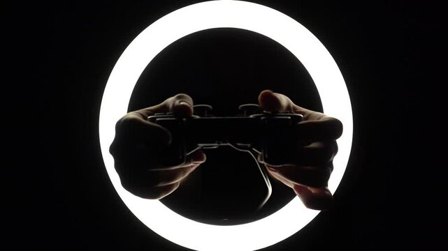 female hands hold a gamepad on a black background. joystick controller for gaming platform close-up. Esports and cybersports concept