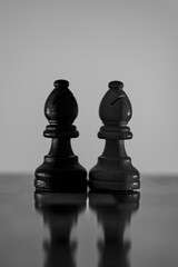 Chess pieces strategically placed on the chessboard symbolize power, vulnerability, and tactical...