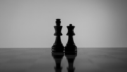 Chess pieces strategically placed on the chessboard symbolize power, vulnerability, and tactical...