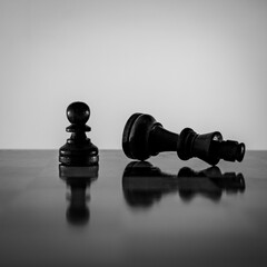 Chess pieces strategically placed on the chessboard symbolize power, vulnerability, and tactical...