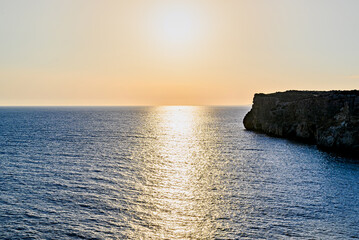 Beautiful sunset with orange sky on the beach of Menorca, Balearic Islands. Sunset, nature	