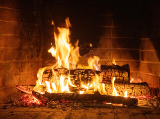Fire flames, wood burning in fireplace. Warm home in winter, heat. Christmas holiday