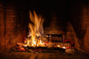 Fire flames, wood burning in fireplace. Warm home in winter, heat. Christmas holiday