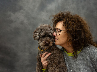 Portrait unconditional love. Woman higging its puppy dog pet.