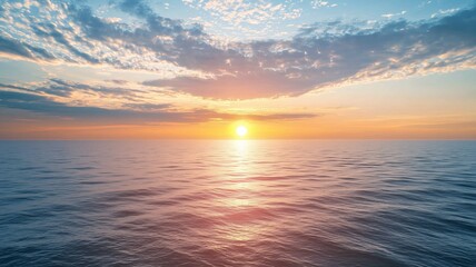 Fototapeta premium Morning sun partially obscured by clouds over the ocean