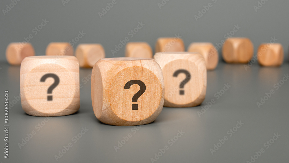 Poster intriguing wooden blocks that are beautifully displaying question marks on a gray surface