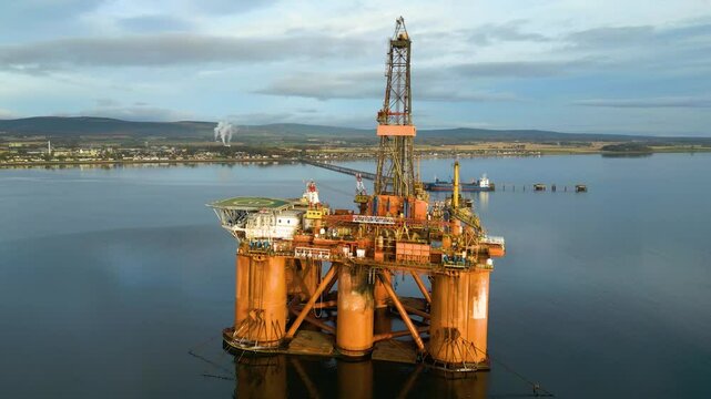 oil rig drilling platform parked estuary waiting for next operational orders role energy production marine forward aerial view infrastructure offshore petroleum 