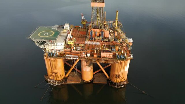 offshore oil rig drilling platform parked estuary role energy production engineering environmental aspects circling aerial footage operational orders marine infrastructure 