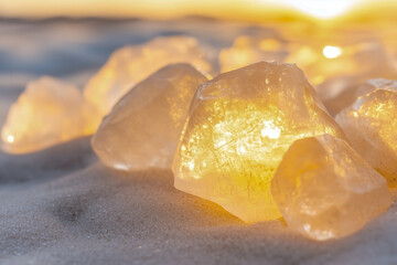 Raw diamonds in their natural state, with rough, uncut surfaces glistening in the light