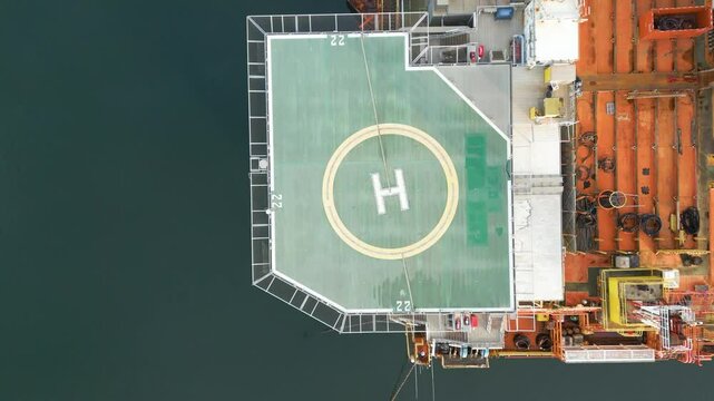 offshore oil rig drilling platform helicopter helipad parked estuary perspective platform's significance energy top down birdseye aerial view production 