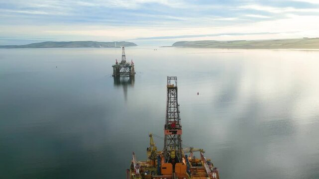 reveals offshore oil rig drilling platform parked estuary role energy production engineering aspects environmental backward aerial view footage operational orders marine 
