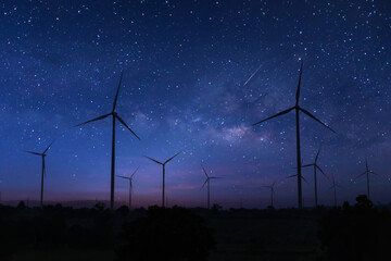 Eco power. silhouette Wind turbines generating electricity with milky way. Milky way over wind...