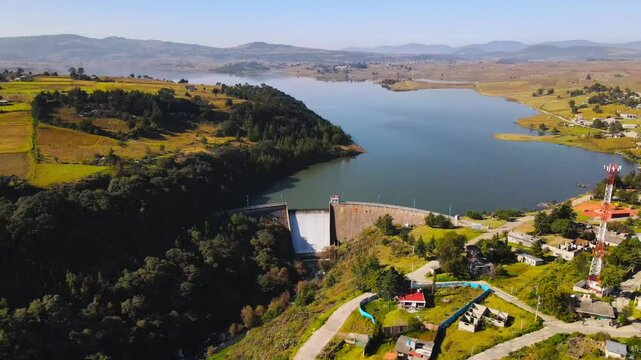 Aerial video in a dolly in shot of a huge dam in the municipality of San Felipe del Progreso, State of Mexico.
