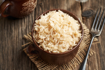 A pot of homemade fermented cabbage or sauerkraut on a table