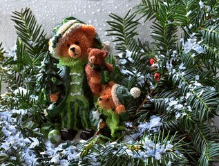 Christmas decoration Christmas bear family on a snowy green branch