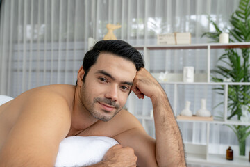 Caucasian man customer enjoying relaxing anti-stress spa massage and pampering with beauty skin...