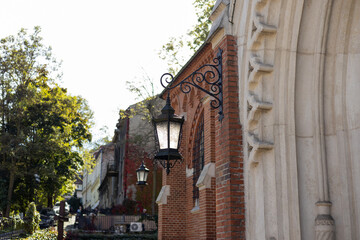 Victorian vintage street lantern at the day time, turned off. The wall lamp on the old street. Old...