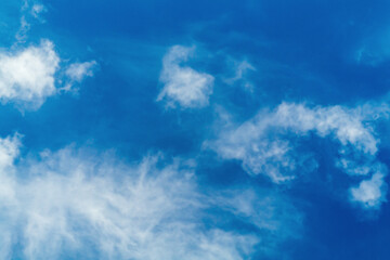 Mixing of huge amounts of air masses by wind and movement by means of pressure differences. A bright blue sky with blurry white haze from clouds. Bottom view. The state of the natural environment