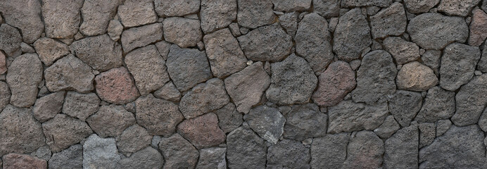 Panoramic background of natural volcanic stone wall from the Canary Islands, with minerals of different colors