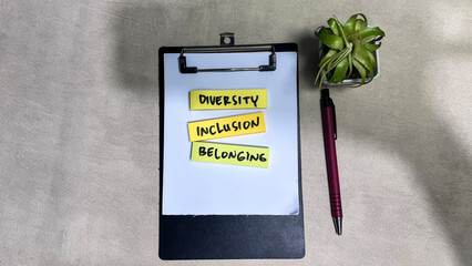 Concept of Diversity, Inclusion, Belonging write on sticky notes isolated on Wooden Table.