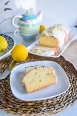 lemon sponge cake glazed in a kitchen with a neutral homemade background