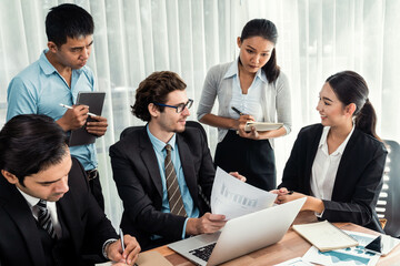 Diverse of business people from various ethnic group working in modern office environment. Productive and multi ethnic office workers engage in discussion for strategic business marketing. Meticulous