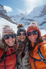 Three friends pose together in the snowy mountains, smiling widely while dressed in winter attire. The bright sun shines above, creating a cheerful atmosphere during their outdoor adventure