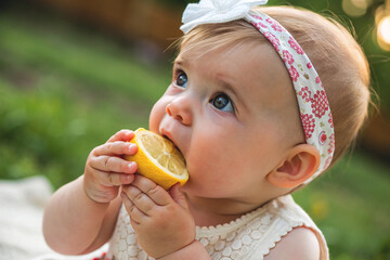 funny baby girl tries lemon for the first time