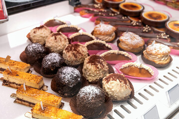 Various assortment of desserts confectionery on the counter in a bakery