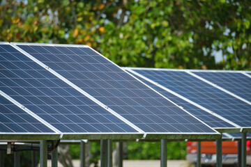 Solar panels installed on stand frame near parking lot for effective generation of clean electricity. Photovoltaic technology integrated in urban infrastructure for electric car charging