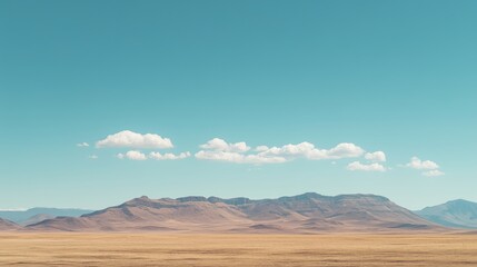 Naklejka premium Vast dry desert landscape meeting majestic mountains under turquoise sky