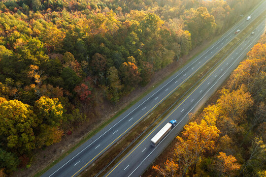 USA highway transportation infrastructure in North Carolina Appalachian mountains. American freeway road with fast driving semi trucks