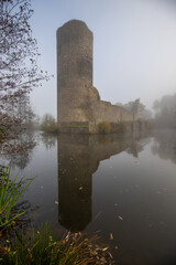 Ruins of a castle. Landscape shot in autumn. Defensive structure in a lake. Misty landscape in the...