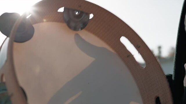 Shadow Of The Hand Playing The Tambourine 