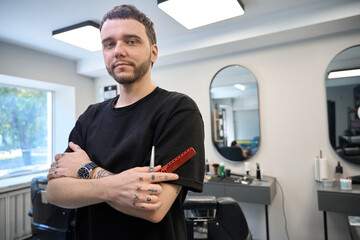 Fototapeta premium Professional hairdresser in salon ready to work