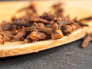 A close-up of aromatic cloves, highlighting the texture and rich color