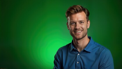 Fototapeta premium Portrait of smiling Caucasian man. Young guy in blue shirt against green background. Happy male model on chroma key. Happy face, teeth, beard, hair, skin. Studio photo.
