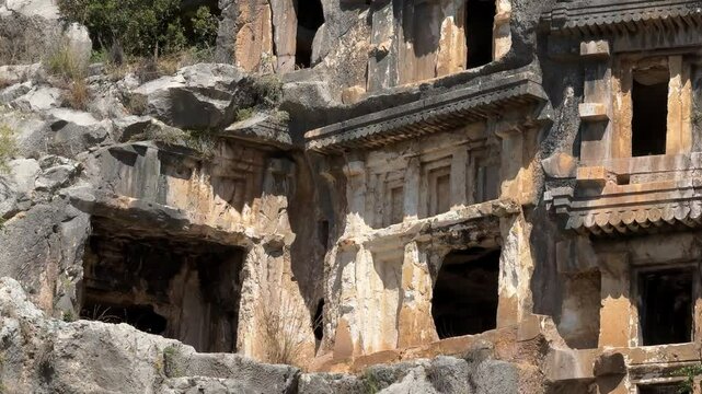 Ruins of the old Lycian rock tombs at the Myra Ancient City on a sunny day in Demre, Antalya, Turkey