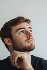 Portrait of a thoughtful person looking into the distance on white background