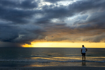 person on the beach at sunset
