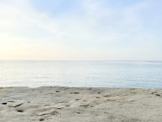 Obraz premium beige natural stone pedestal on calm sea background. product display. promotion. mockup. light background. waterline background. seawater surface. minimalistic background