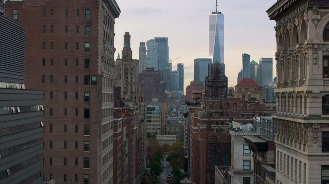 Aerial view of the tribeca neighborhood in New York City. The camera pans across the rooftops of buildings, revealing One World Trade Center in the distance