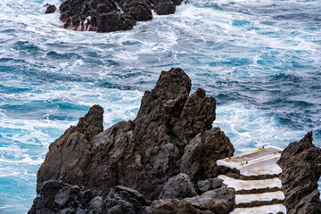 Porto Moniz Madeira Portugal Waves crashing over rocks around natural pools