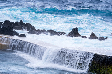 Porto Moniz Madeira Portugal Waves crashing over rocks around natural pools