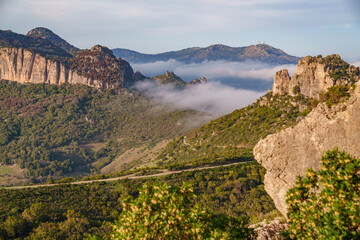 Beautiful view of the mountain panorama with fog rolling between the peaks