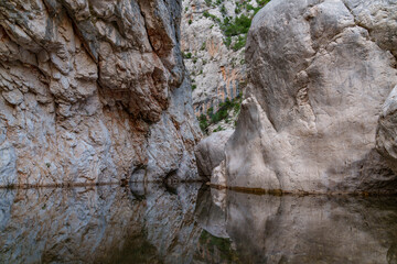 Very high rocky banks of Gorropu Canyon with a view of its bottom