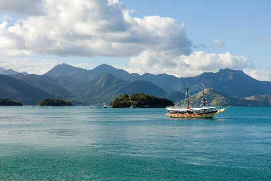 Schooner on Ilha Grande (Big Island), sea of ​​Angra dos Reis Bay with beautiful large mountains in the background, beach vacation on the coast of Rio de Janeiro, Brazil