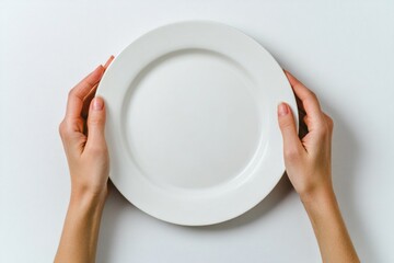 Two hands grasping a white plate on a clean surface, perfect for showcasing food or other items