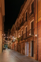 A view of an empty street, beautifully lit at night.